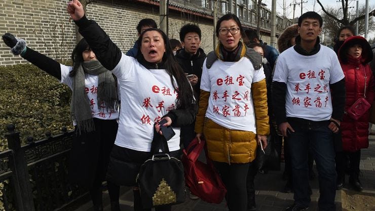 Investors in Chinese online peer-to-peer lender Ezubao protest in Beijing on February 4, 2016, Getty Images, CNBC